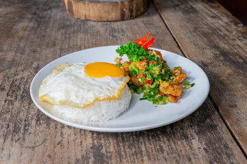 Delicious Salt Pepper Chicken or Ayam Cabe Garam with Fried Egg on Steam Rice