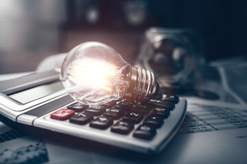 light bulb represents business good idea on calculator and  financial, budget or asset document in workplace.  Idea, Corporation, Enterprise concept.