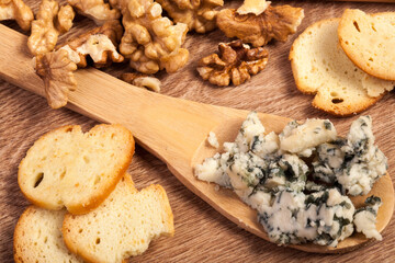 Crackers, white cheese and honey on wooden background in studio photo