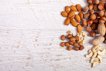 Different nuts on wooden background in studio photo