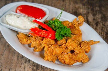Delicious Fried Crispy Chicken Made from Breast and Skin's Chicken on White-Oval Plate