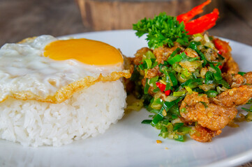 Delicious Salt Pepper Chicken or Ayam Cabe Garam with Fried Egg on Steam Rice