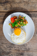 Delicious Salt Pepper Chicken or Ayam Cabe Garam with Fried Egg on Steam Rice