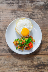 Delicious Salt Pepper Chicken or Ayam Cabe Garam with Fried Egg on Steam Rice