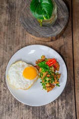 Delicious Salt Pepper Chicken or Ayam Cabe Garam with Fried Egg on Steam Rice