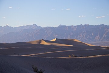 The Mesquite Flat sand dunes rise above Stovepipe Wells in Death Valley, with the Panamint Range...