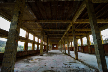 big hall with columns in an abandoned factory building