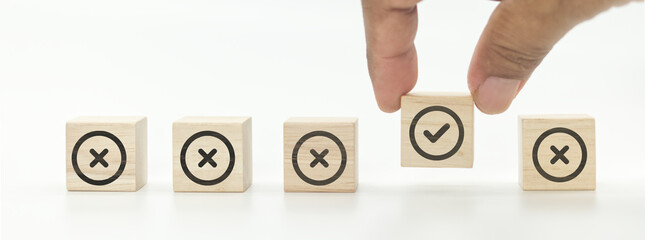 Checkmark and cross icons on wooden cubes on white background. Regulatory compliance, project feasibility concept. Tick and cross signs,approve and disapprove symbols.