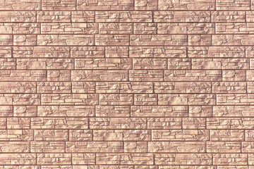 Wall of brick siding as an abstract background. Texture