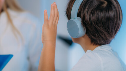 Hearing Test for Children. Audiologist Working with a Preschooler Boy