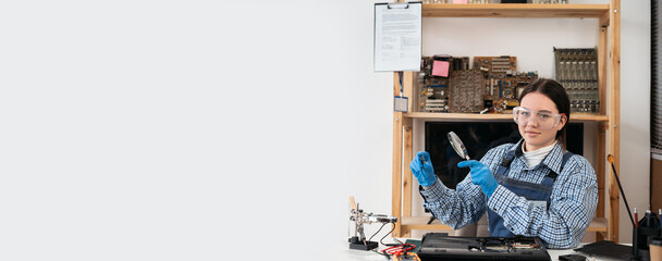 Engineer repairs laptop support fixing notebook computer. IT woman using magnifying glass looking on computer CPU in service center.