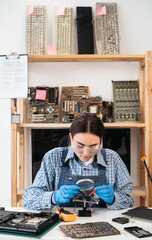 Fototapeta na wymiar Engineer woman repairs laptop support fixing notebook computer. Repairman tinkering computer component.