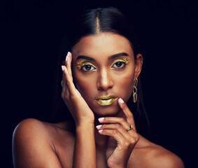 Gold makeup, serious and portrait of a woman isolated on a black background in a studio. Beauty,...