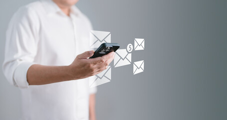 Businessman using smartphone with e-mail icon. Communication and Technology concept..Email marketing or newsletter, Contact us by newsletter email, Scheme of direct sales in business.
