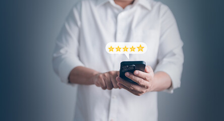 Customer holding smartphone give a five star rating for feedback review satification service, Concept of service rating,  Experience and Feedback for business satisfaction survey.