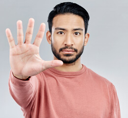 Portrait, five and hand for stop, Asian man and warning with serious expression against a grey studio background. Face, Japanese male and guy with gesture for halt, raising palm and showing number