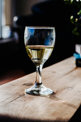 Glass of White Wine on Wooden Coffee Table