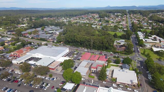 Aerial drone pullback reverse view of Ulladulla in the City of Shoalhaven, NSW, Australia, from above Ulladulla Harbour 