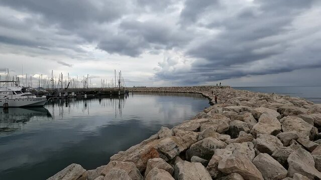 The beach and marina, in Larnaca, Cyprus, against a background of a cloudy winter sky