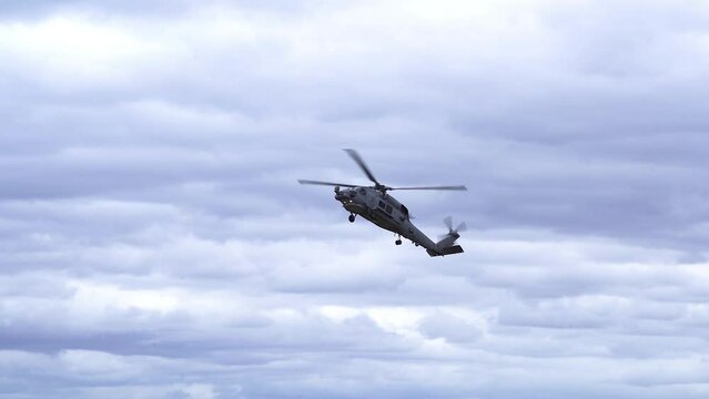 MH-60R Seahawk Helicopter Against Cloudy Sky - low angle