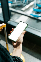 Using phone in travelling. Blank screen smartphone at the airport before the flight. Application for travel, banking, concept.