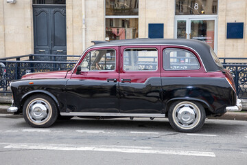 british london black burgundy taxi cab on a london street