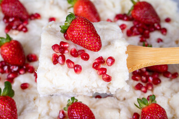 Gullac dessert. Traditional Ramadan dessert. Close-up of gullac dessert with pomegranate and strawberry