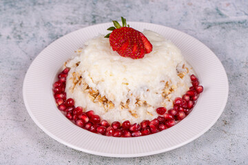 Gullac dessert. Traditional Ramadan dessert. Gullac dessert with pomegranate and strawberry on the plate