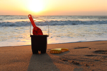 Sand toys for making sand castle on sandy beach in sea shore at sunset time , summer holiday...