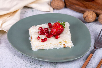 Gullac dessert. Traditional Ramadan dessert. Gullac dessert with pomegranate and strawberry on the plate