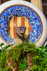 Multicolored mosaic snake of Gaudi in Park Guell, Barcelona, Spain