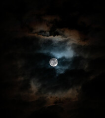 Naklejka na ściany i meble Moon illuminates colorful clouds.