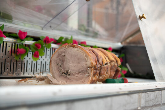 Porchetta lies in glass case in Rome.