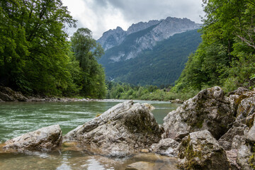 Rocks on the shores of Austria's Lammer River with beautiful mountain backdrop