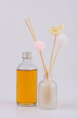 Diffuser bottles with sticks isolated on white background 