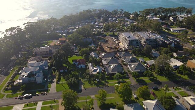 Aerial drone view of Huskisson in the City of Shoalhaven on the shores of Jervis Bay, NSW, Australia, heading toward Huskisson Beach on a bright sunny morning    