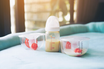 Electronic pump full with bottle of mother breast milk, breast milk storage and handling concept.selective focus.