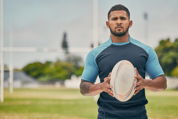 Rugby, field and portrait of man with ball, serious expression and confidence in winning game. Fitness, sports and player training for match, workout or competition on grass at stadium with mockup.