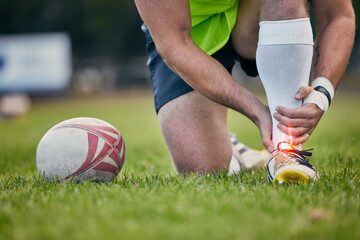 Rugby, pain and man with foot injury on sports field for practice match, training and game on grass. Medical emergency, accident and male athlete with joint inflammation, ankle sprain and tendinitis - obrazy, fototapety, plakaty