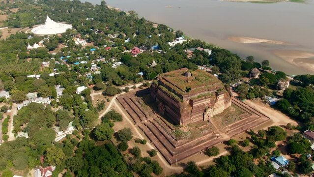 Aerial drone panning shot of the giant Mingun Pahtodawgyi in Myanmar on a sunny day