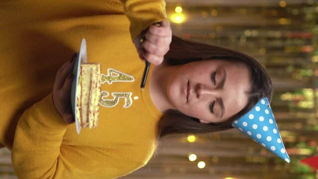 Beautiful happy young woman wearing sweater holding birthday cake number 45 golden candles burning by lighter. Concept of celebrating birthday and anniversary. POV.