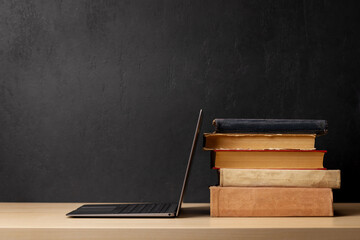 Laptop and stack of books