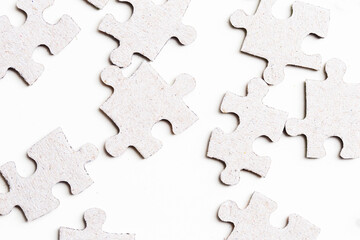 Pile of puzzle background. Puzzle pieces in mess texture. Symbol of chaos in life. Putting pieces together. Many parts stacked. Isolated on white.