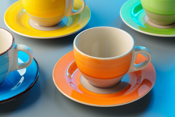 Colorful clay ceramic cups on gray background