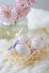 Easter decor in the form of eggs, flowers nearby