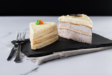 Set of cake portions, carrot cake and chocolate cake on marble.