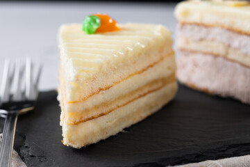 Sweet carrot cake slice on marble surface. Close up