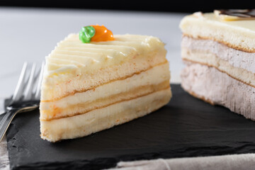 Sweet carrot cake slice on marble surface. Close up