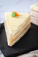 Sweet carrot cake slice on marble surface. Close up