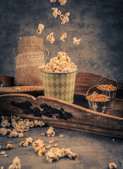 Popcorn in a paper cup on a blue background. Toned.